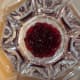 Using a clear glass bowl, ideally a trifle bowl, add ingredients in layers. The first layer is the cranberries.