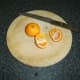 Clementine oranges are halved fro stuffing in to duck