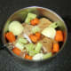 Ingredients for ham stock are added to the pot