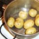 Boiled potatoes are drained and left to cool