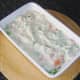 Fish pie filling is spread out in a dish