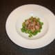 Chopped bacon is scattered on watercress