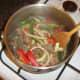 Pepper and onion slices are stirred through browned pigeon and venison