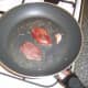 Pigeon breasts are added to the frying pan