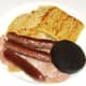 Sausages and black pudding are laid on bacon