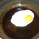 Frying an egg sunny side up