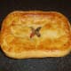 Rabbit and pork pie is removed from the oven and rested