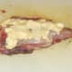 Rubbing butter on rabbit saddle