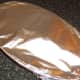 Tinfoil covers rabbit saddle for roasting