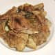 Rabbit and pork pieces are removed from pot