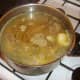 Chicken stock is added to cover rabbit and pork