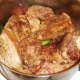 Rabbit and pork is re-added to pot with vegetables