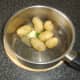 Butter and chives are added to drained new potatoes