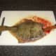 Knife is inserted in to flounder's belly cavity