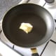 Butter is added to small, non-stick frying pan
