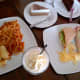 A spread of food at Cafe Cristina (clockwise): cappuccino cheesecake, chocolate cake, tuna and crab sandwich, chocolate milkshake, and tuna and tomato pasta.