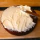 Spreading the topping on the cooled cake