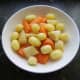 Cooled potatoes are peeled and mixed with carrot and parsnip