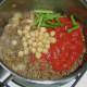 Tomatoes, beans and chickpeas are added to curried mince