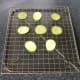 Courgette and aubergine slices are drained and rested on a wire rack