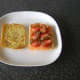 Basil is scattered over strawberries and smoked salmon