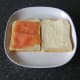 Smoked salmon is laid on one slice of the buttered bread