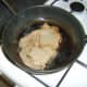 Rib eye steak is turned halfway through cooking