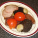 Bacon, tomato and mushrooms are added to the plate