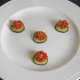 Cherry tomato and cucumber garnish is plated