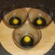 Quail eggs broken into glass bowls