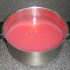 Strained rowan berry and apple liquid with sugar
