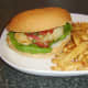 Chicken burger with pineapple salsa and fries is ready to eat.