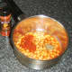 Smoked paprika and basil are added to baked beans in tomato sauce