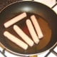 Frying pork sausages