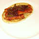 Beans and sauce are spooned on top of sausages