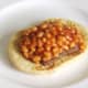 Spicy baked beans are spooned on to Lorne sausage