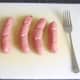 Beef sausages are pricked with a fork