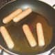 Pork sausages are gently fried in oil