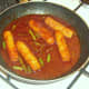 Sausages and beans are gently simmered in spicy szechuan tomato sauce