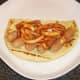 Indian spiced onions are spooned on to pork sausages