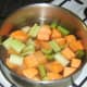 Chopped celery and sweet potato added to turkey stock