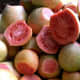 Peel guavas first if you want to cook the shells. For nectar cut shells in half and scoop out the pulp.