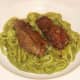 Lambs liver is laid on bed of tagliatelle pasta in pea and mint sauce