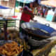 Street vendors selling banana fritters. He uses the pisang abu.