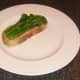 Drained tenderstem broccoli is laid on bruschetta