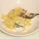Banana is mashed with the back of a fork