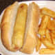 Chips are added to the plate with the sub roll and battered hot dog