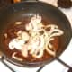 Mushroom and onion added to fried spices