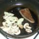 Onions and mushrooms are added to pan with frying ox liver.