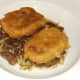 Corned beef fritters are laid on bed of stir fried cabbage and kidneys
